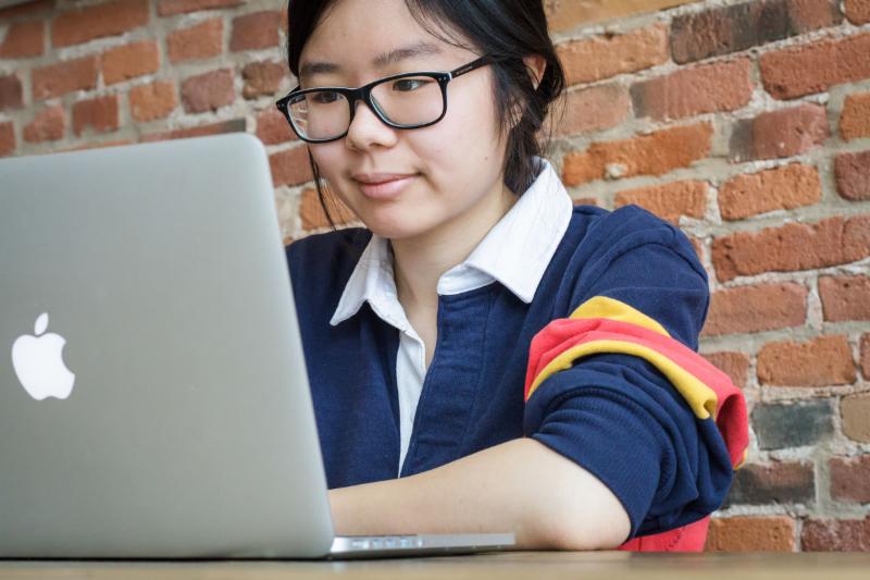 Queen's student using a laptop