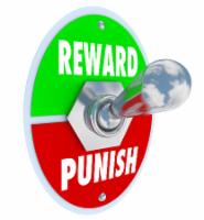 Reward and Punish words on a toggle switch or lever to illustrate disciplining a child, student or worker for good or bad behavior or performance