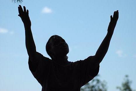 Silhouette of a man with upraised arms
