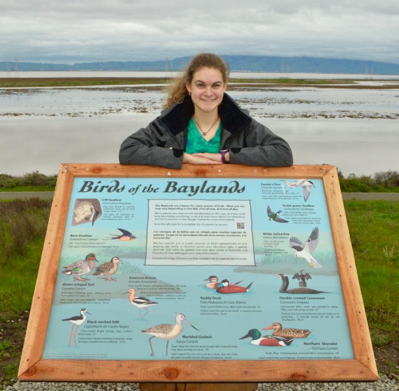 Photo of Sophie with one of her signs at the Baylands