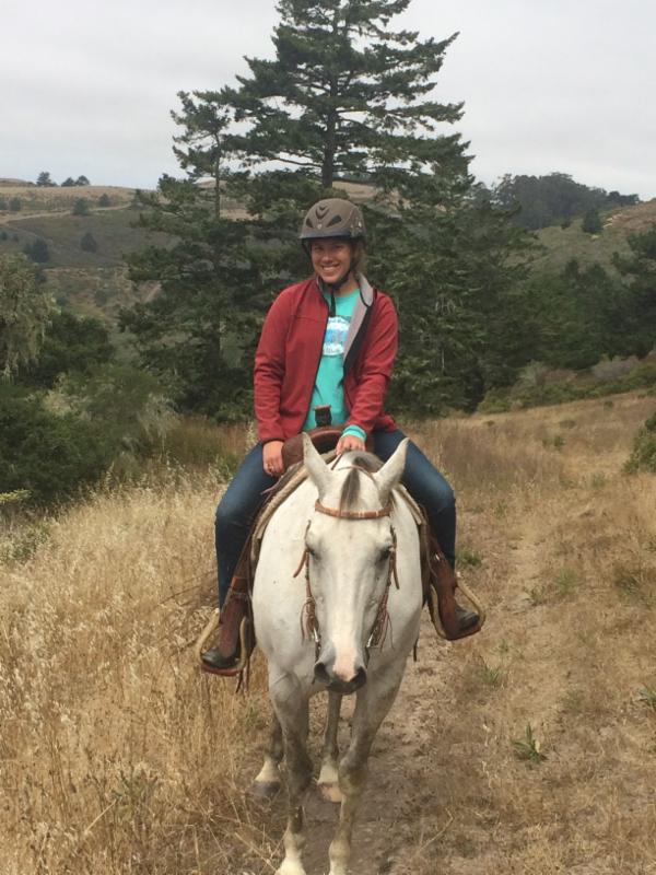 Photo of Catie at TomKat Ranch riding a horse