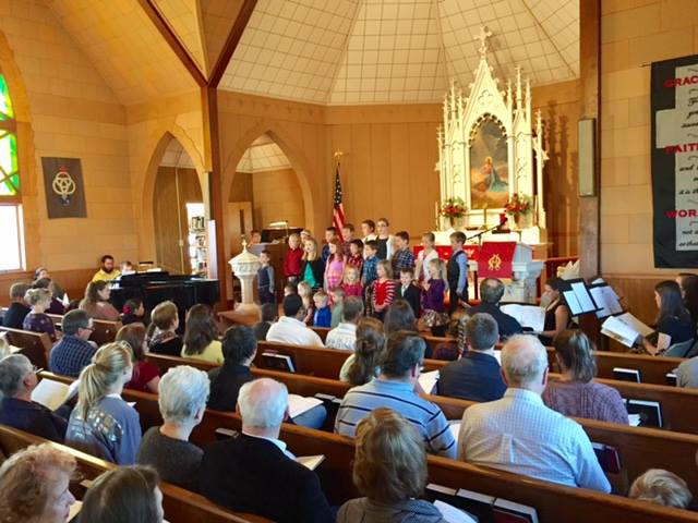 children singing in church at hymn festival
