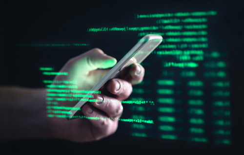 Darkweb_ darknet and hacking concept. Hacker with cellphone. Man using dark web with smartphone. Mobile phone fraud_ online scam and cyber security threat. Scammer using stolen cell. AR data code.