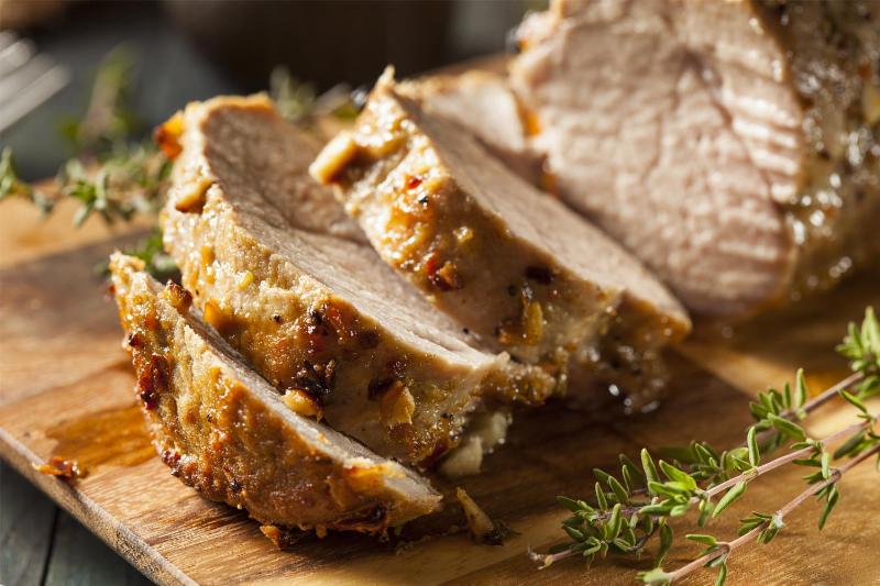 Sliced pork loin on a cutting board.