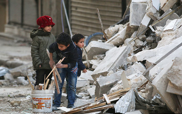 Children collect firewood amid damage and debris at a site hit by airstrikes in the al-Shaar neighborhood of Aleppo, Syria November 17, 2016. Photo: REUTERS/Abdalrhman Ismail.