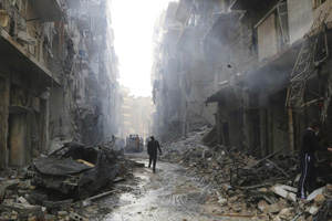 People inspect damage at a site hit by what activists said were barrel bombs dropped in Aleppo's district of al-Sukari on March 7, 2014.
