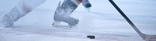 ice hockey player in action kicking with stick
